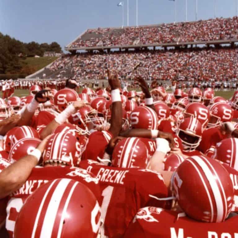 Football players huddle in celebration