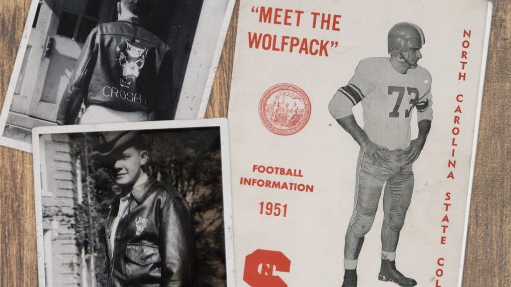 A flat-lay image shows two black-and-white snapshots of a man wearing a Wolfpack leather jacket, along with a brochure that says "Meet the Wolfpack. Football Information. 1951."