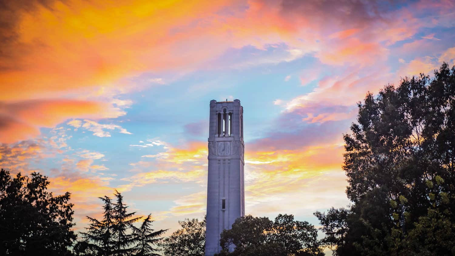 A golden sunset behind the Belltower on NC State's main campus.