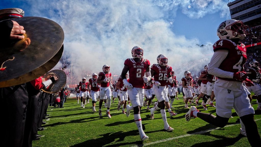 The NC State football team takes to the field against Clemson in 2021.