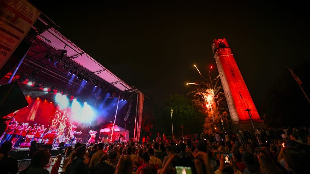 The NC State belltower is lit red at Packapalooza 2019.