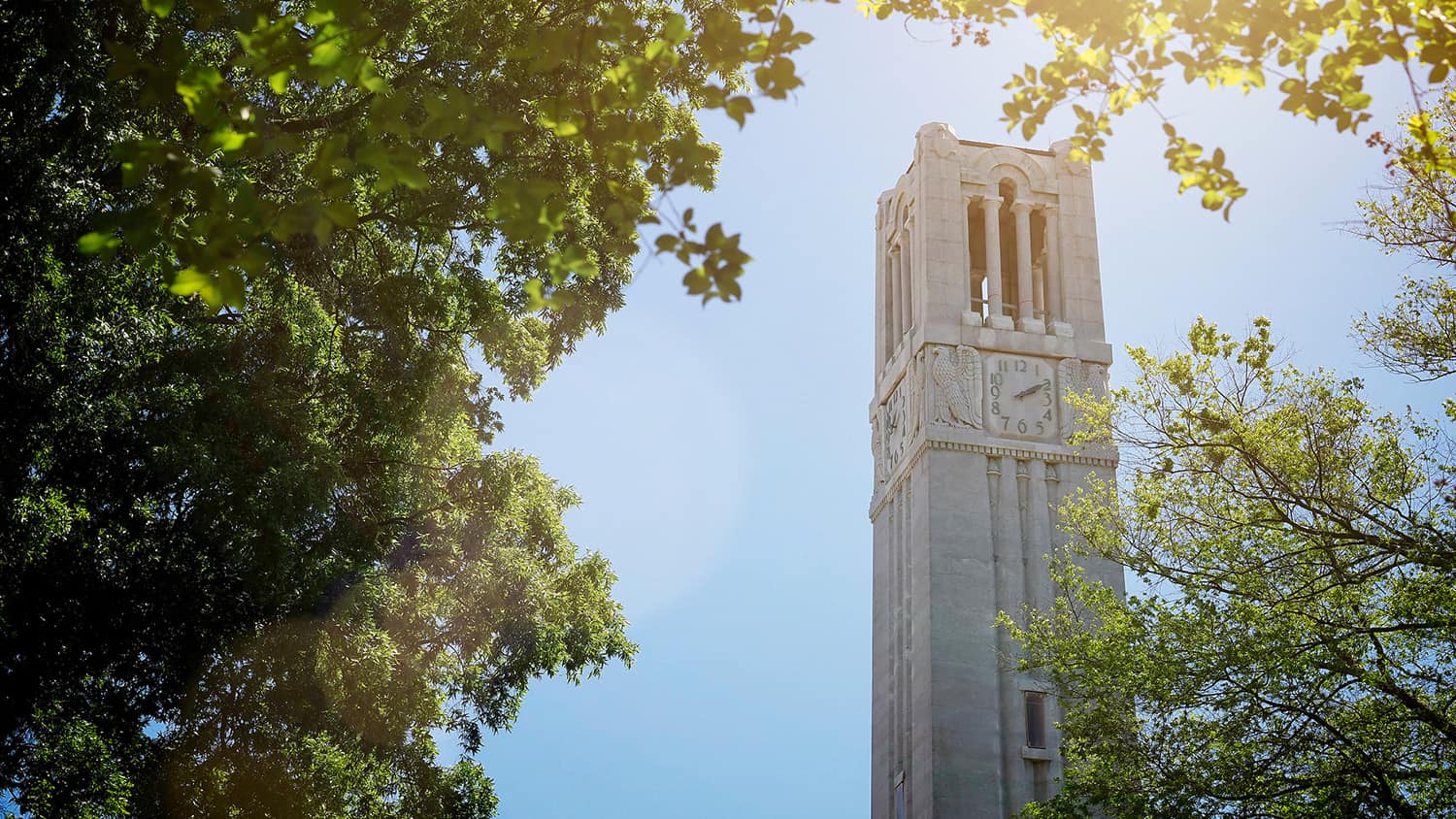 The NC State belltower shines as a beacon of hope over the campus of NC State.