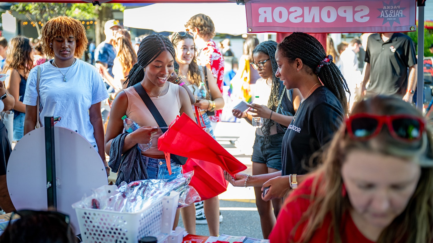 A student stops by a street vendor during Packapalooza, NC State's all-day street festival kicking of each new school year.