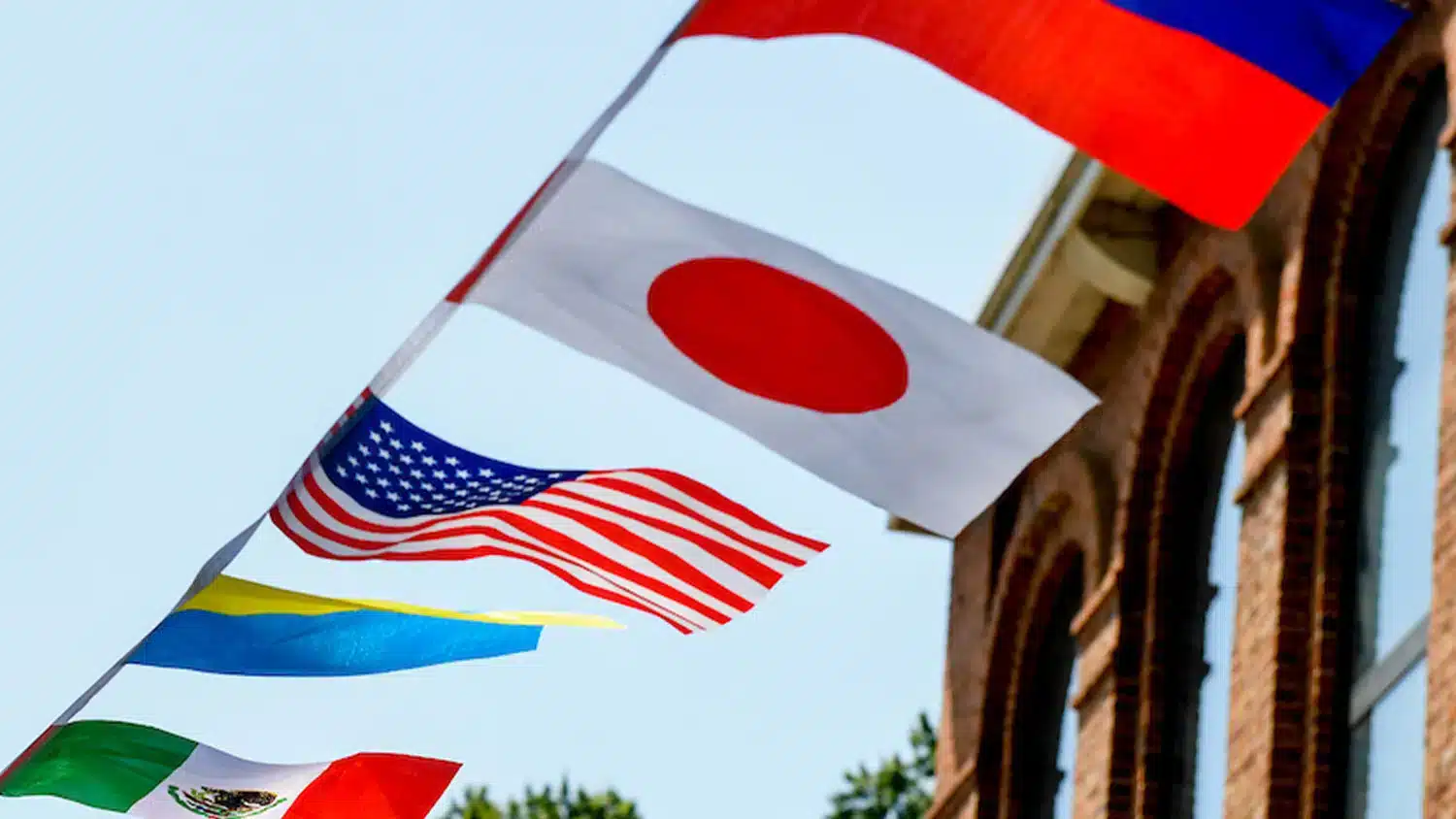 A string of national flags at NC State, including the flags of Japan and the United States.